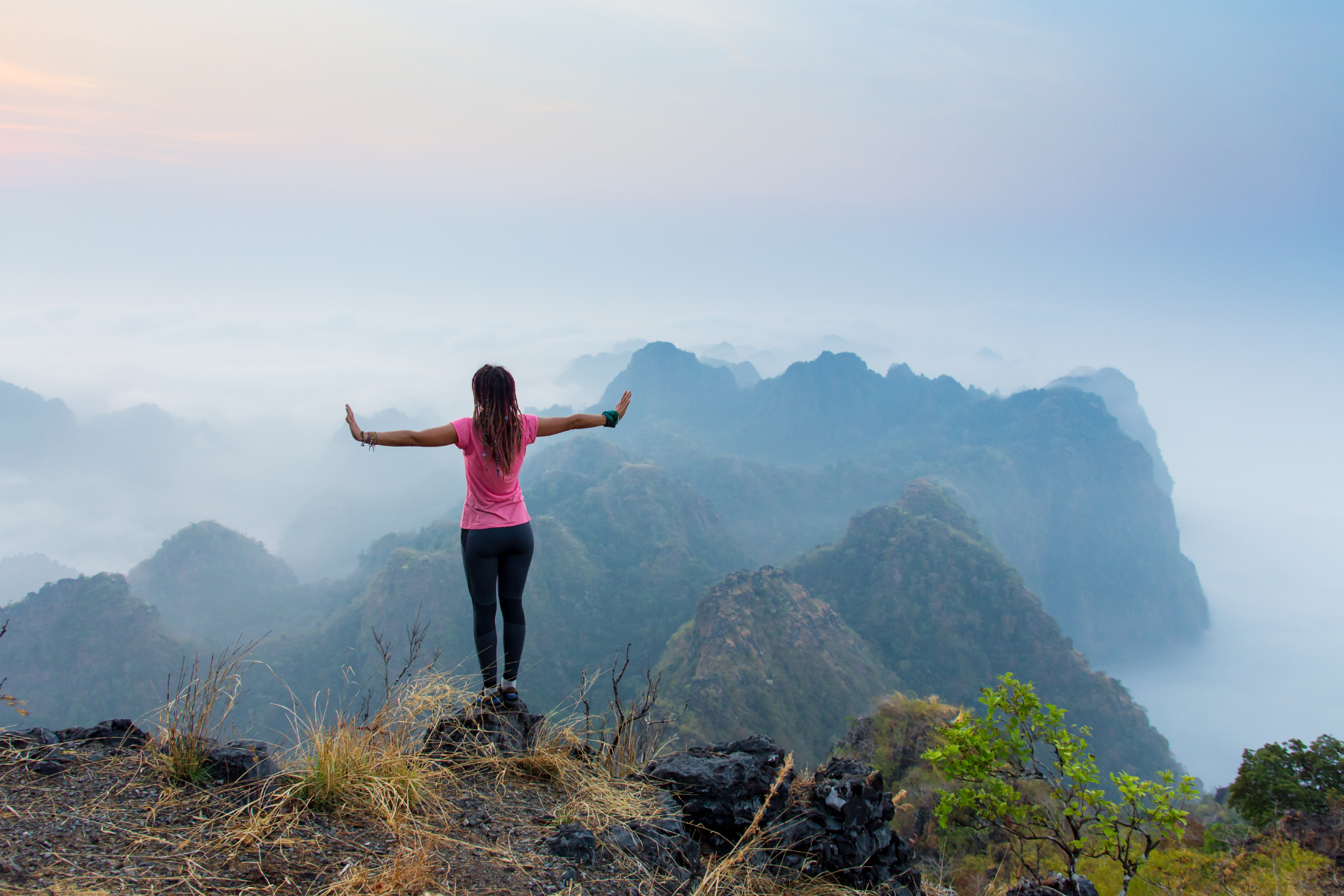 Woman meditating on mountain